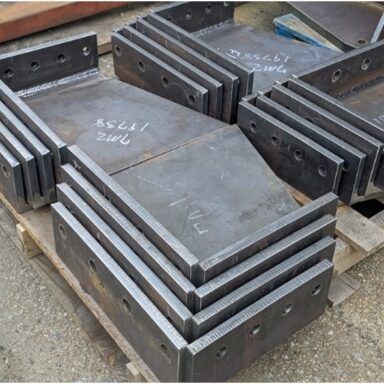 1-1/2” thick plate welded to form custom corner bracket supports with precision holes from the drill line for structural connections